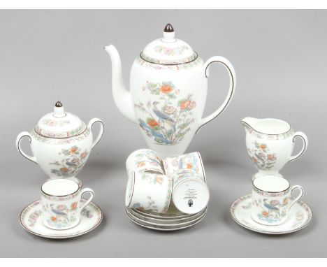 A Wedgwood bone china six place coffee set decorated in the Kutani Crane pattern includes coffee pot, cream jug, sucrier and 