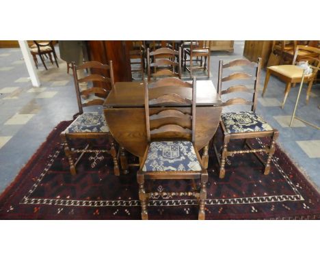 An Edwardian Oak Gate Legged Drop Leaf Dining Table and Four Ladder Back Dining Chairs 