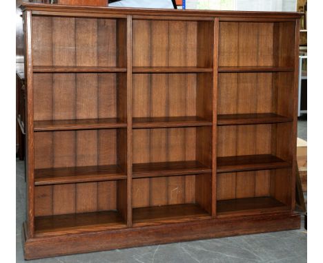An Edwardian oak bookcase, with adjustable shelves, 149cm h; 35 x 178cm A well made bookcase in good condition save for stain