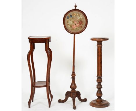 A Victorian walnut pole screen,&nbsp; on carved tripod with circular framed floral woolwork banner, 137cm h, an Edwardian mah