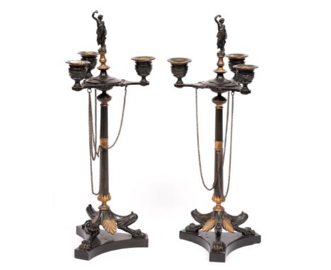A pair of Napoleon III gilt and patinated bronze candelabra of three lights, on fluted shaft and three lion monopodia, slate 