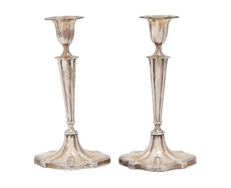 A pair of George V silver candlesticks, with reeded borders, nozzles, 30cm h, by Walker &amp; Hall Ltd, Sheffield 1921, loade