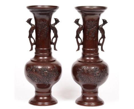 A pair of Japanese bronze twin-handled vases, Meiji period, with flared neck, decorated with birds and flowers, 38cm h 
