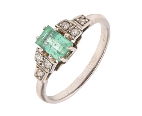 An emerald and diamond ring, the step cut emerald between millegrain set diamond shoulders, in platinum, 2.8g, size K Undamag
