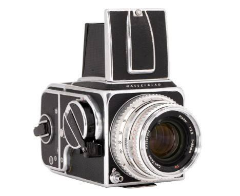 A Hasselblad 500CM medium format camera, chrome, No UP144128, with Carl Zeiss planar 80mm F2.8T lens, No 5567902 Camera worki