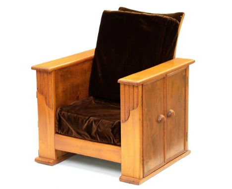 An Art Deco varnished light wood armchair,&nbsp; the sides with shelves, on one enclosed by two doors, 79cmh 
