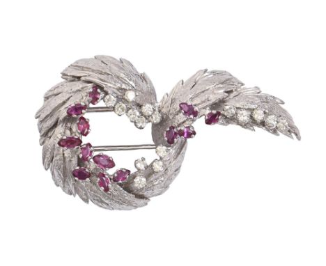 A ruby and diamond brooch, of leafy entwined design, with melee of even round brilliant cut diamonds and smaller rubies, 52mm