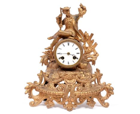 A French giltmetal figural mantle clock, early 20th c, mounted with a huntsman, with enamel dial, pendulum, 34cm h Good condi