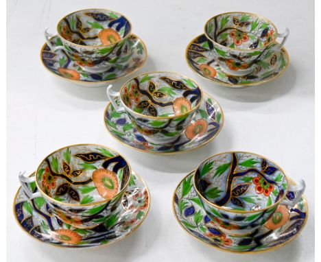 A set of five Coalport teacups and saucers, c1810, boldly painted in underglaze blue and enamelled and gilt with a floral pat