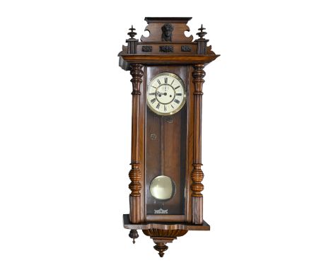 A walnut Vienna wall clock, c.1900, with primrose enamel dial, pendulum, 120cm h 