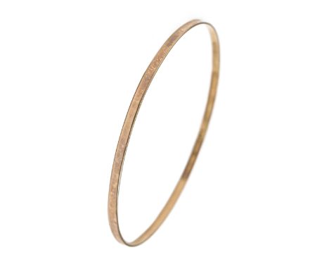 A gold bangle, 66mm diam, marked 9ct, 4.4g Wear scratches