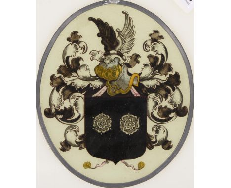 A Northern European stained glass armorial window light, 19th c, with crest, shield, helm and leafy mantling, oval, 25cm h Un