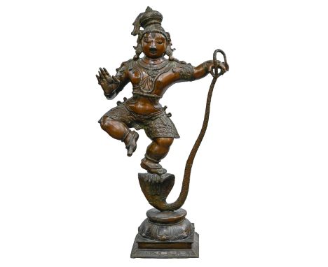 An Indian bronze statue of Krishna dancing on Kaliya, 90cm h 