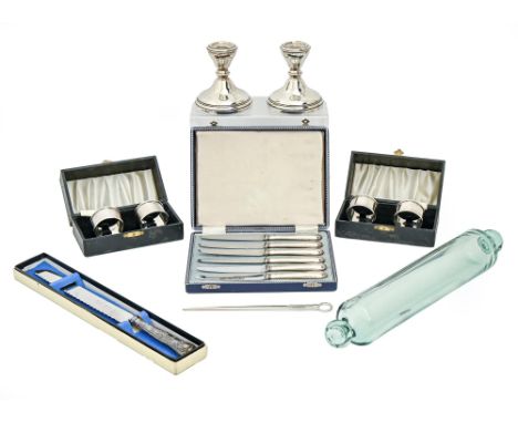 Two pairs of Elizabeth II silver napkin rings, by Harman Brothers, Birmingham 1956, both cased, a pair of silver candlesticks