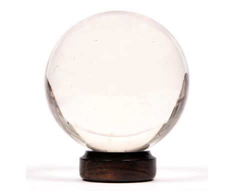 Divination. A crystal ball, early 20th c, of rock crystal, 14cm h, wood stand (2) A good example, not chipped, a few light sc