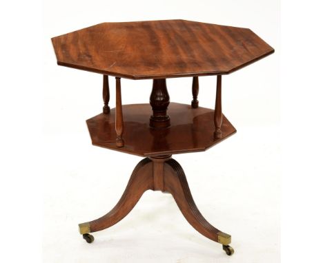 A George III octagonal mahogany two-tier tripod table, with revolving top, on reeded legs with brass castors, 75cm h; 76cm x 