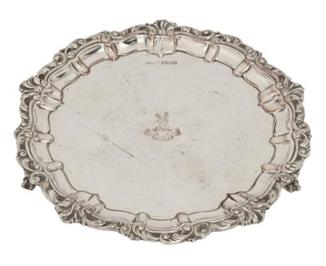 A George V silver salver, on three claw and ball feet, crested, 25.5cm diam, by John Henry Potter, Sheffield 1912, 16ozs 18dw