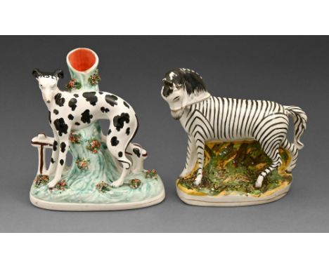 A Staffordshire earthenware spill holder model of a 'Disraeli' spaniel and a contemporary model of a bridled zebra, mid 19th 