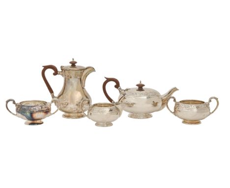 A George VI four-piece silver tea service and an Elizabeth II additional silver sugar bowl, with floral engraved border, lidd