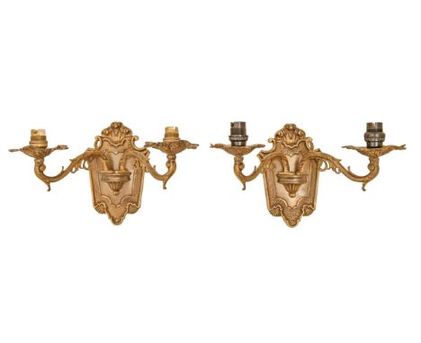 A pair of gilt lacquered brass twin light wall sconces, mid 20th c,&nbsp;in regence style with cartouche shaped wall plate, 2