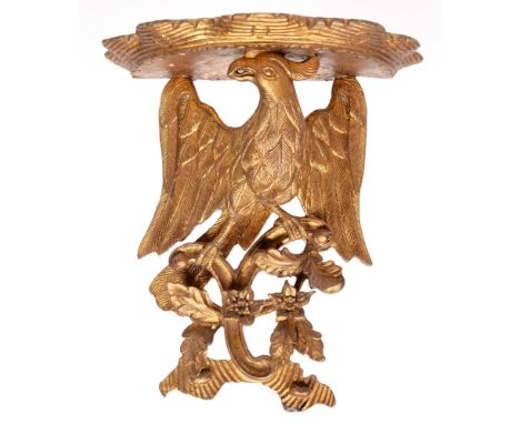 A carved and pierced giltwood and composition bracket, in the form of an eagle, 37cm h 