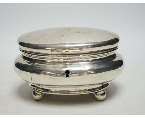 A 19th century German? white metal oval tea caddy, on bun feet, lacking key, width 16cm, 8.8oz.