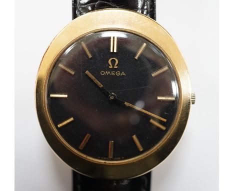 A gentleman's 9ct gold black dial manual wind wrist watch, with Omega box.