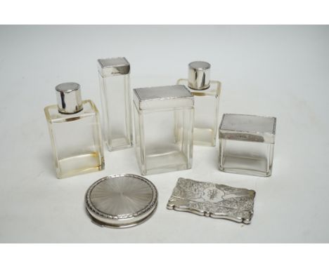 Five assorted silver topped glass toilet jars, a silver compact and an Edwardian engraved silver card case, Birmingham, 1902,