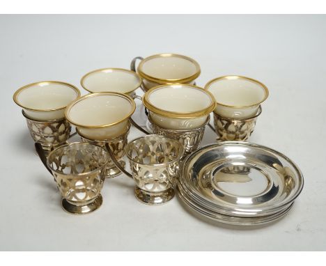 A set of six Limoges Lenox coffee cups with sterling holders and saucers and a pair of larger similar cups with holders and s