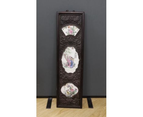 A Chinese famille rose porcelain panel, housed in a carved hardwood frame, 106cm high