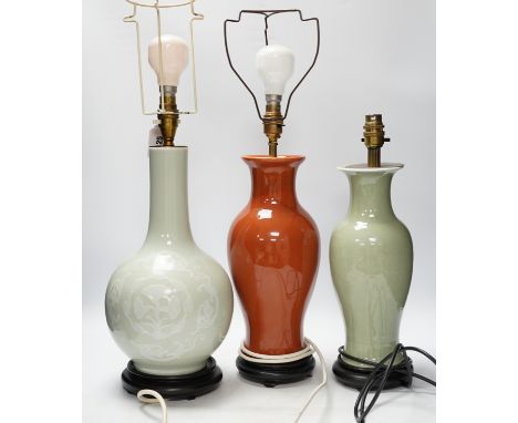 Three Chinese monochrome porcelain lamp bases, 20th century, tallest 38cm high Rust-coloured lamp with long, vertical crack, 