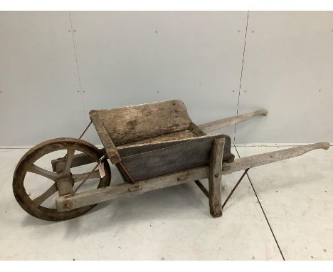 A vintage provincial iron bound wood wheelbarrow, length 180cm