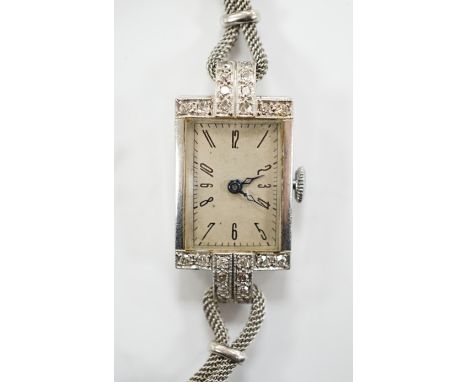 A lady's white metal and diamond set rectangular dial manual wind cocktail watch, on a 9ct white gold, bracelet, gross weight