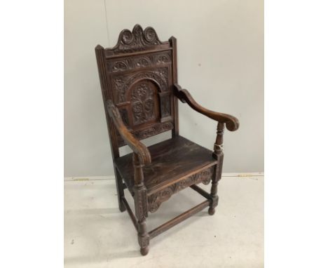A 19th century oak panel back wainscot armchair, width 57cm, depth 54cm, height 117cm