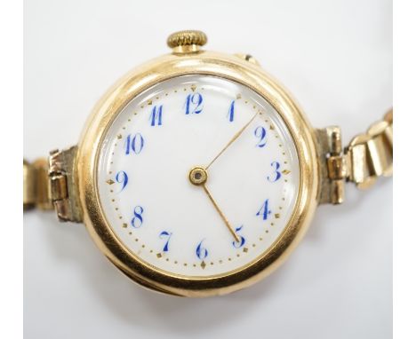 An early 20th century 15ct gold manual wind wrist watch, on a rolled gold bracelet.