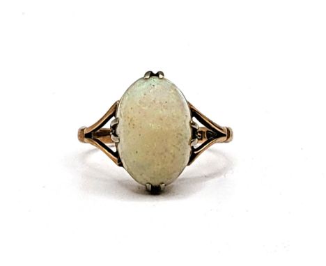 A rose gold (marks worn) split shank set with a large cabochon cut opal ring. 2.2gms size K. Stone in need of a polish.