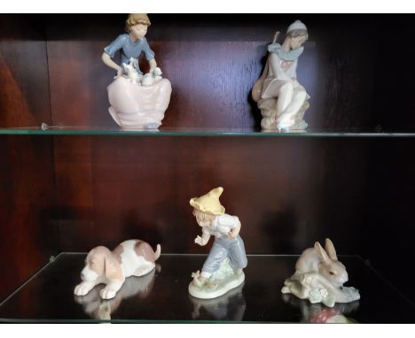 Lladro rabbit and sleeping dog 16cm and 11cm long, and three Nao figures 15cm to 18cm high. (5)All very good condition with n