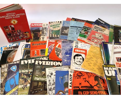 A collection of rare football programmes dating from the 1960's and an album of official photographs of Man Utd players, four