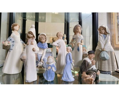 Three Lladro figures of girls 20cm to 26cm, and six figures by various makers including Nao girl with kitten. (9)in good cond