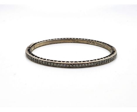 A silver Pandora hinged bangle blue enamel and paste set with a profile cut out heart design. 12.0gms