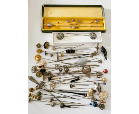 A collection of hat pins including a boxed set of studs and pins with engine turned blue enamel centres, porcelain topped, co