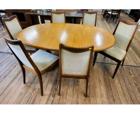 A G-Plan extending oval dining table and a set of six chairs with light upholstery. 73cm x 208cm (fully extended) x 106cm. Sp
