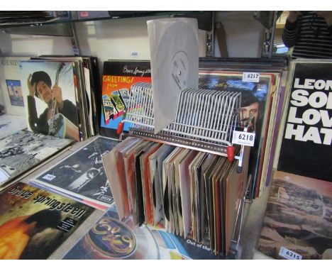Three record storage racks and a quantity of 7" singles including The Rolling Stones, Gene Vincent and Poz