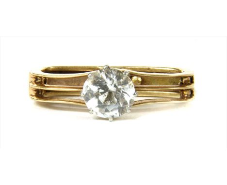 A gold white sapphire scarf ring, an old European cut white sapphire, claw set to three row wire upper half, plain lower half