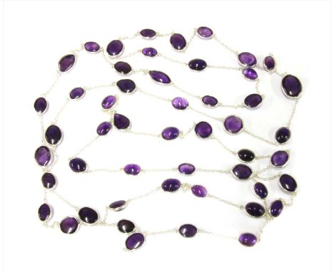 A silver amethyst long chain, oval, pear, marquise and circular cabochon amethysts, all spectacle set and joined by lengths o