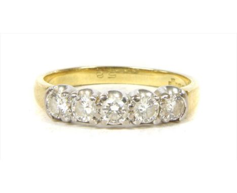 An 18ct gold five stone diamond ring, by Fred Ullmann. A row of brilliant cut diamonds, claw set in white gold, to plain yell