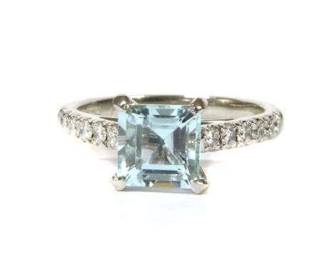 A platinum aquamarine and diamond ring, a square step cut aquamarine, claw set to parallel shoulders micro claw set with a ro