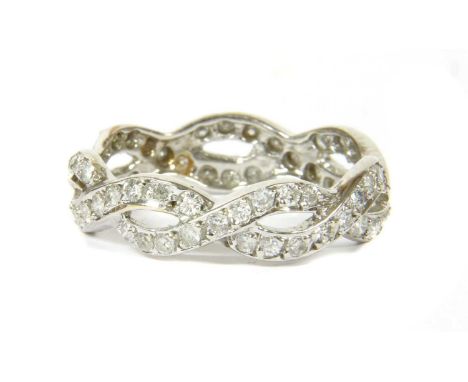 A white gold diamond ring, of plaited design, each strand grain set with brilliant cut diamonds. Tested as approximately 18ct