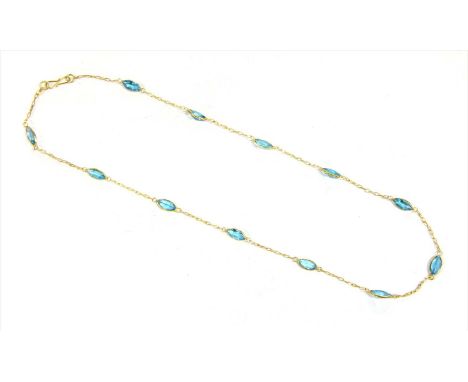 A gold blue topaz rivière necklace, marquise shaped mixed cut blue topazes, all spectacle set and joined by lengths of trace 