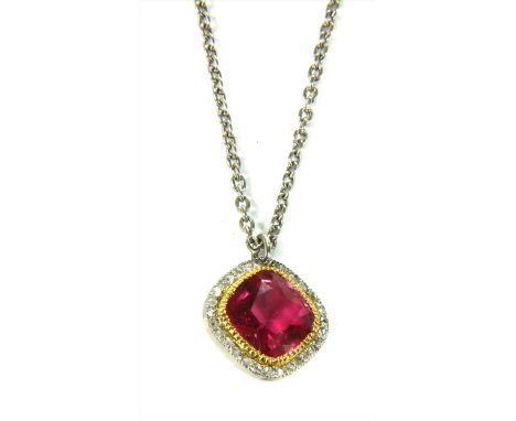 A platinum pink tourmaline and diamond halo cluster pendant, a cushion cut pink tourmaline, milligrain set to a halo of rose 